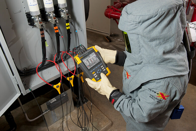 Worker analyzing data whilst wearing protective equipment