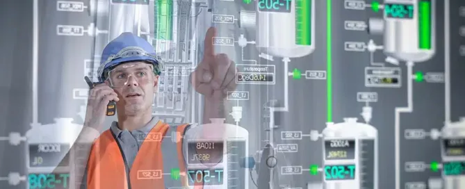 Man in a blue hard hat holding a walkie talkie up to his ear