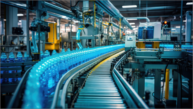 Long line of plastic drinking bottles in a food and beverage packaging plant